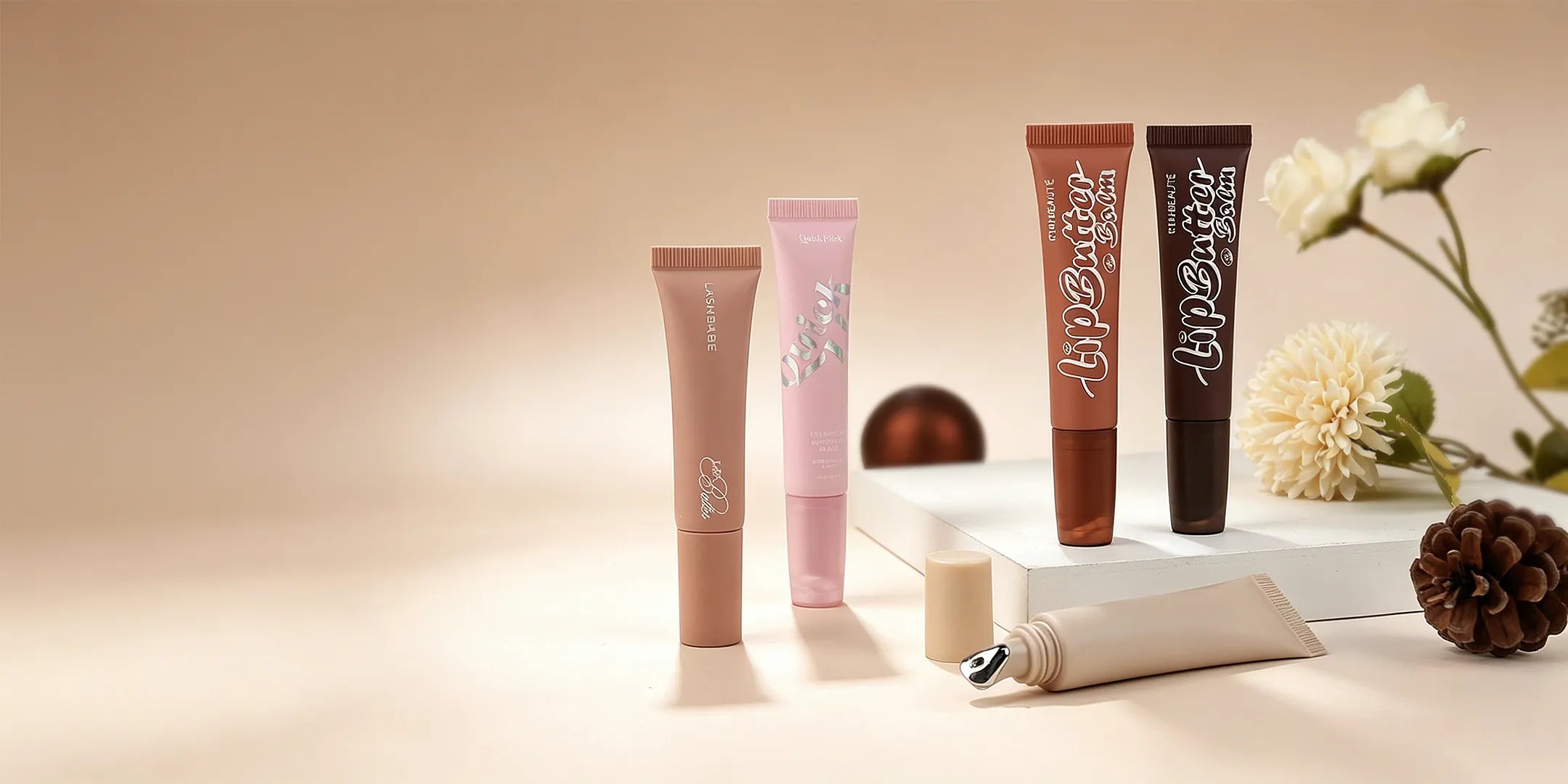 Kaiya lip gloss squeeze tube containers in soft colors for custom lip gloss packaging projects.