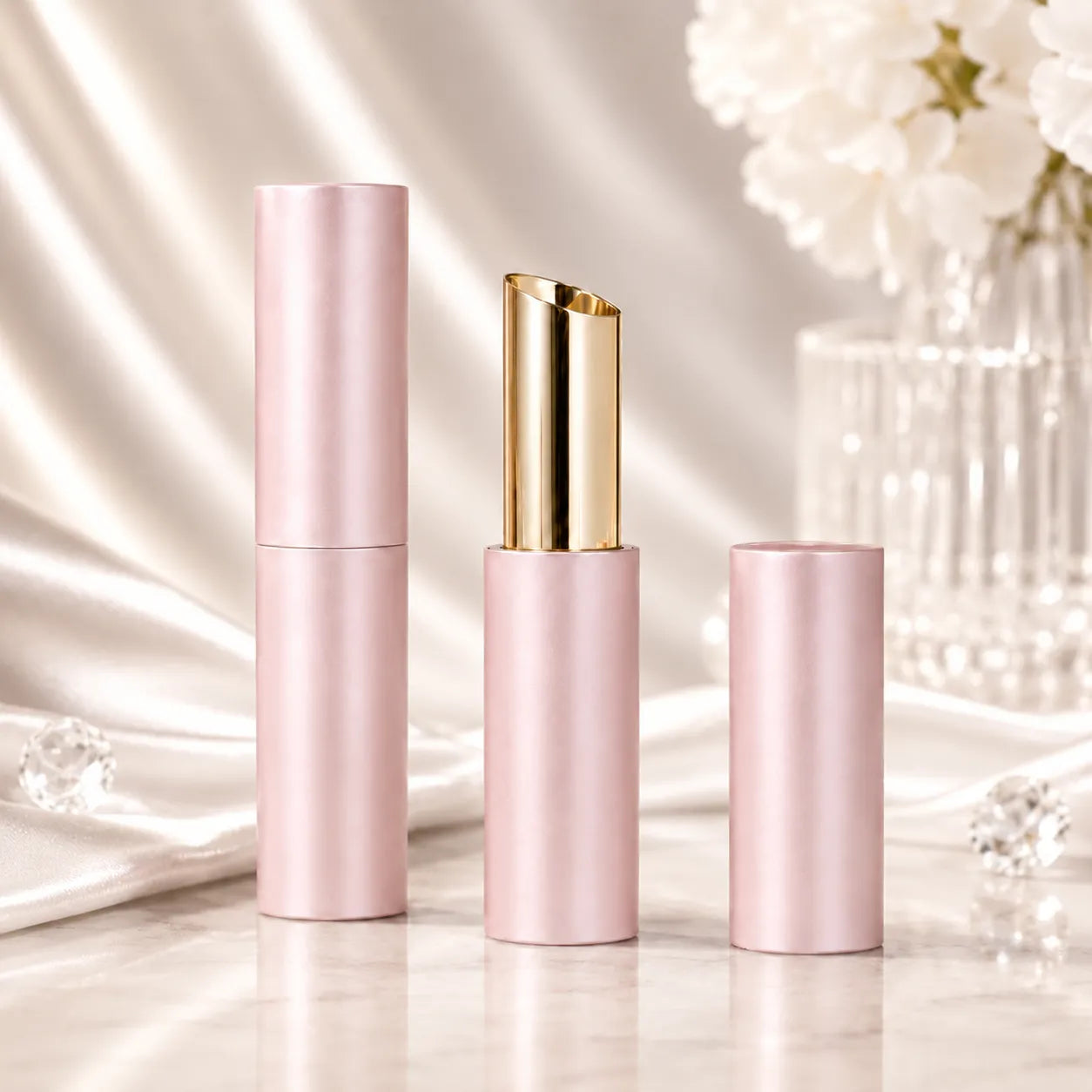 Aluminum lip balm tubes with pink metal outer shell and gold inner tube for premium lip balm packaging