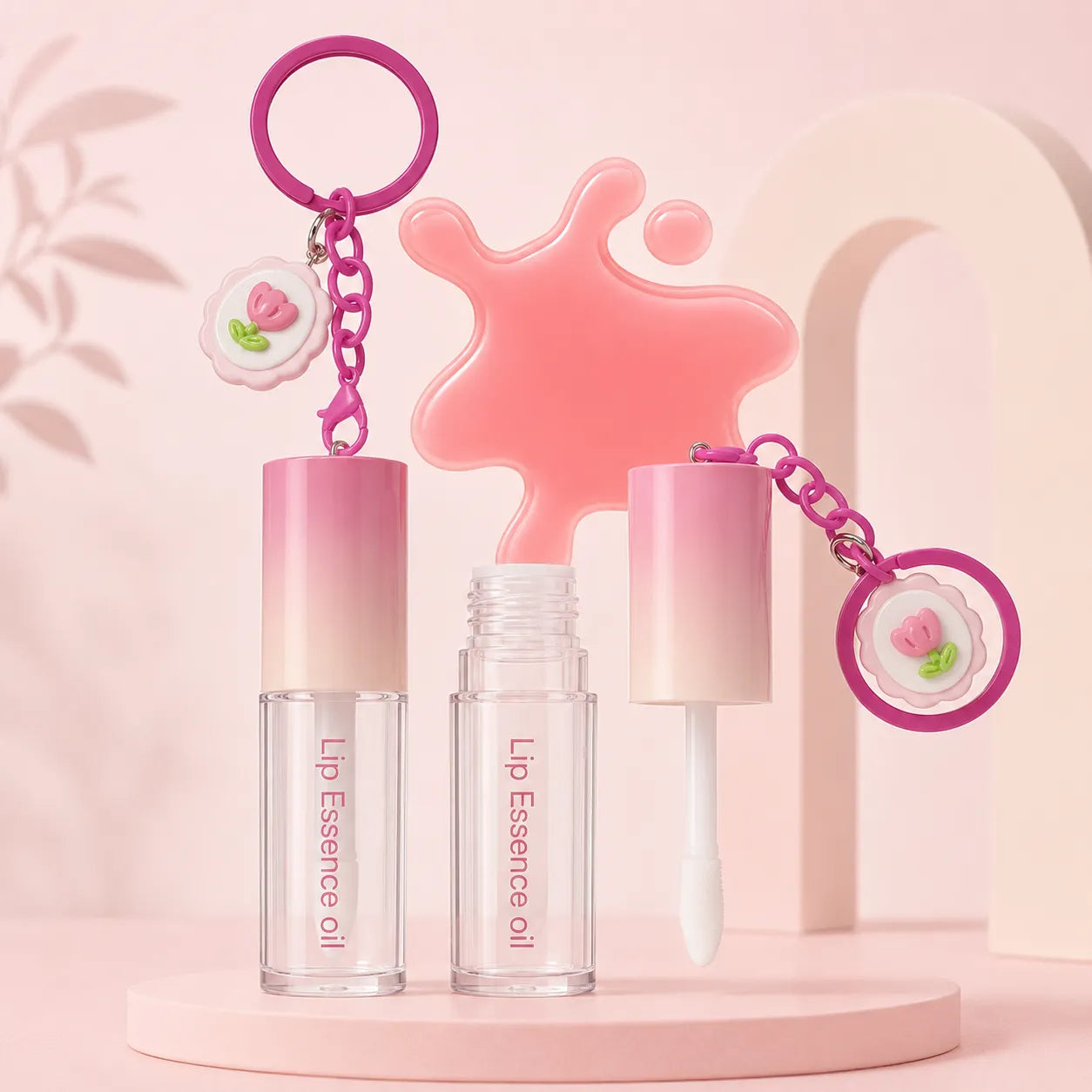 Empty lip oil tubes with hanging keychain design and clear bottle packaging for custom lip care products.