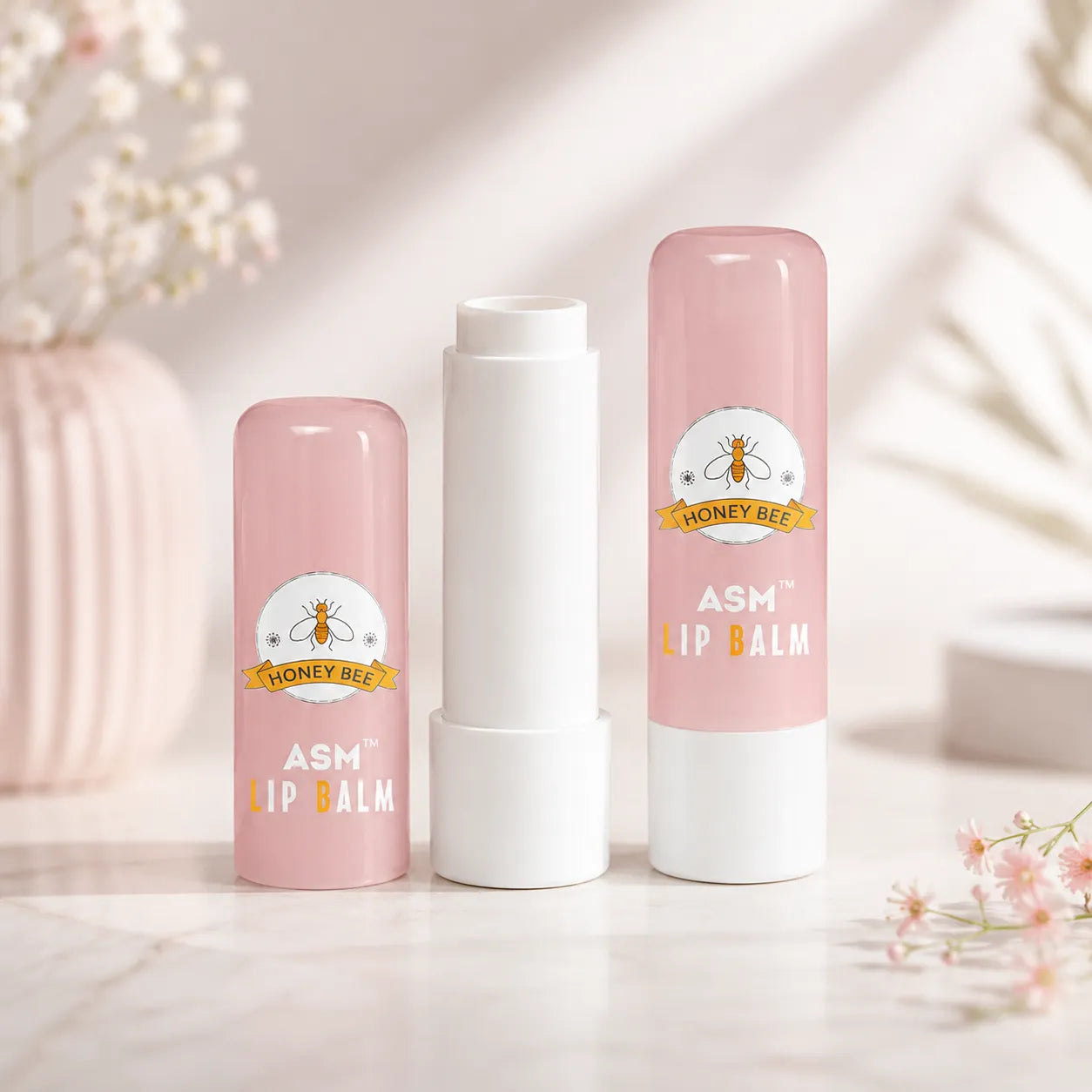Pink lip balm container with 3D printing artwork and raised honey bee logo detail, suitable for custom cosmetic packaging and colorful lip balm tube projects.