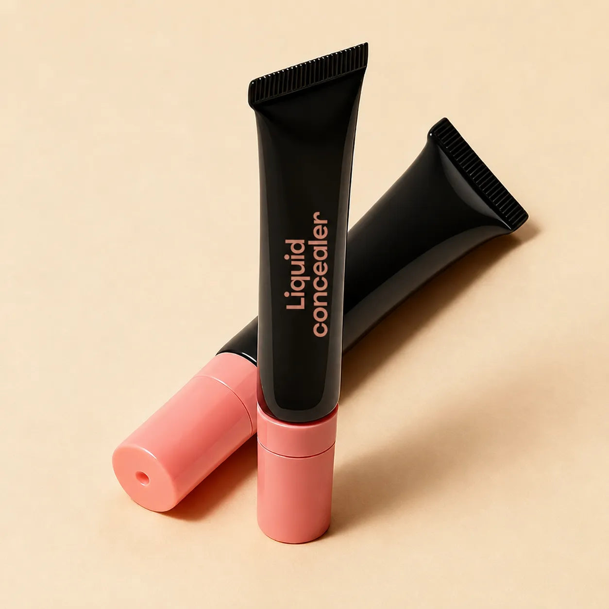 Black lip gloss squeeze tubes with pink caps in cosmetic squeeze tube packaging by Kaiya