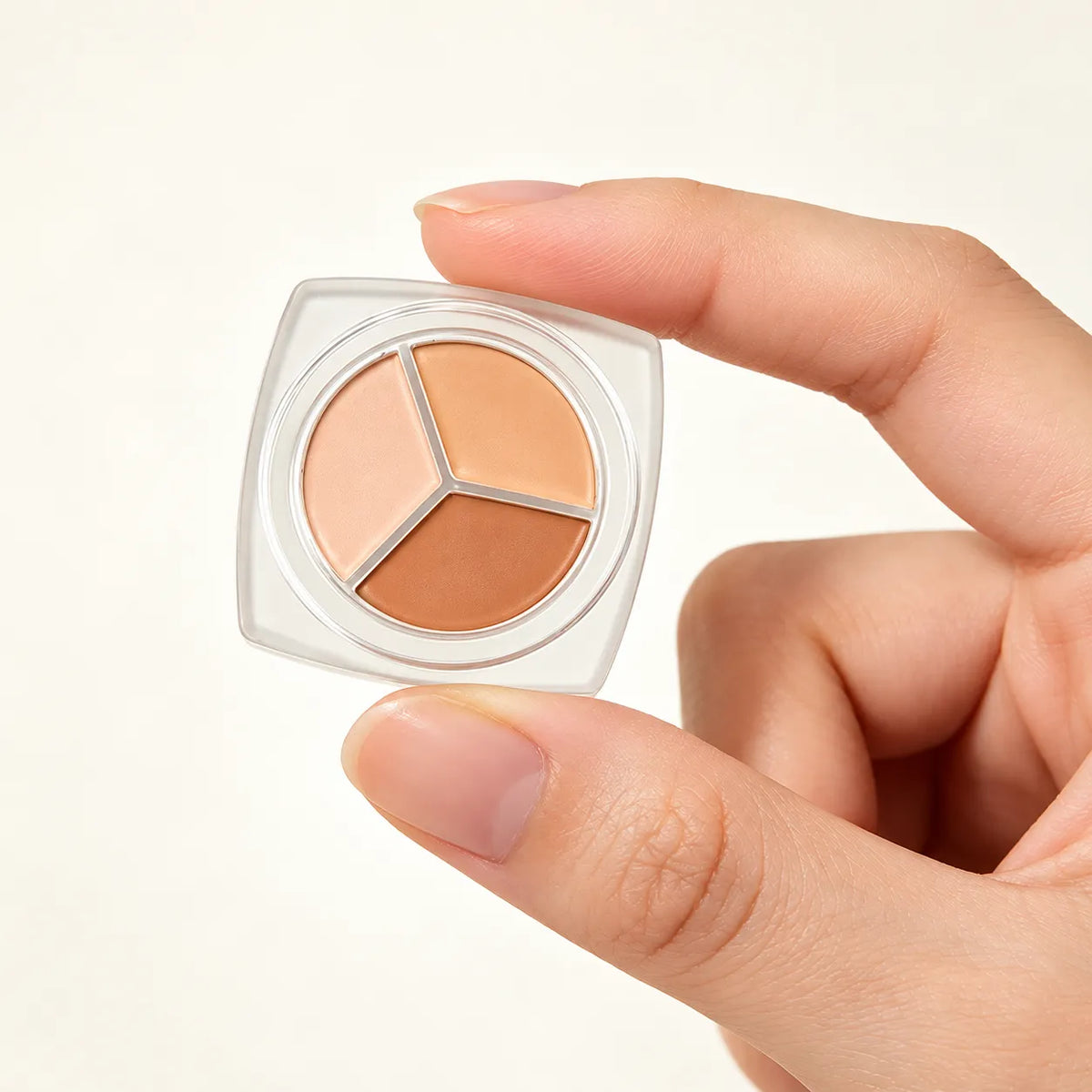 Three-shade cream concealer palette for private label makeup development, featuring light, medium and deeper skin-tone colors.
