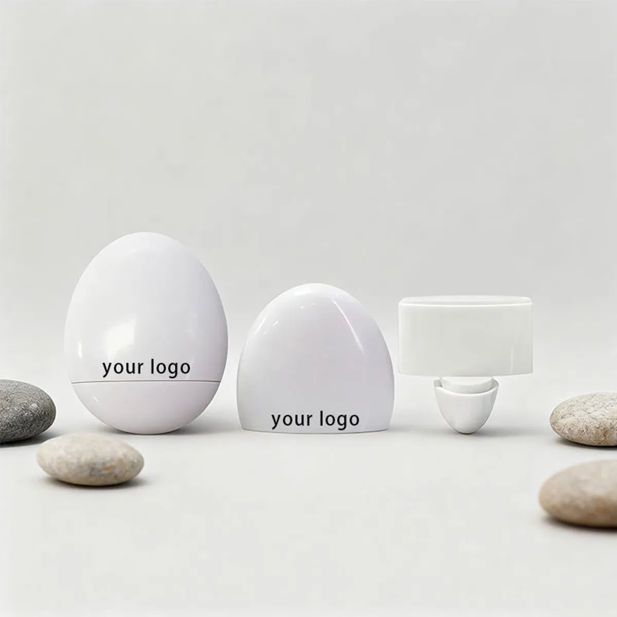 Empty lip balm containers by KAIYA, featuring custom lip balm packaging in clean white dome and cap structures for cosmetic brands.