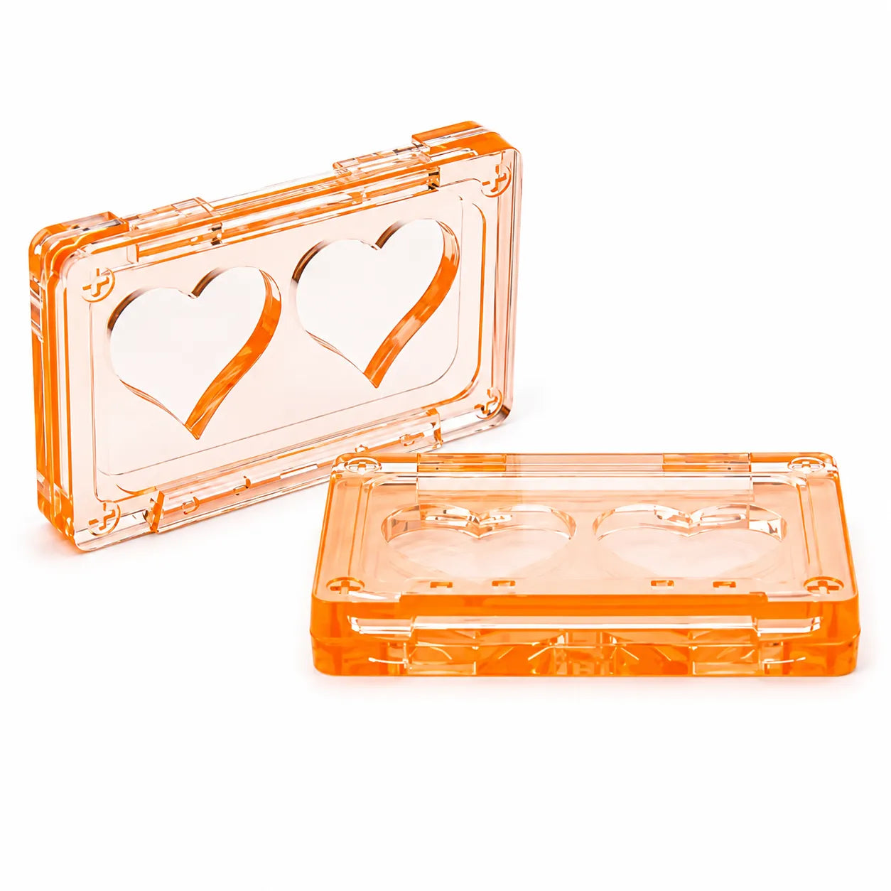 Heart shaped blush compact case in transparent orange plastic with dual heart pan design for blush or highlighter packaging