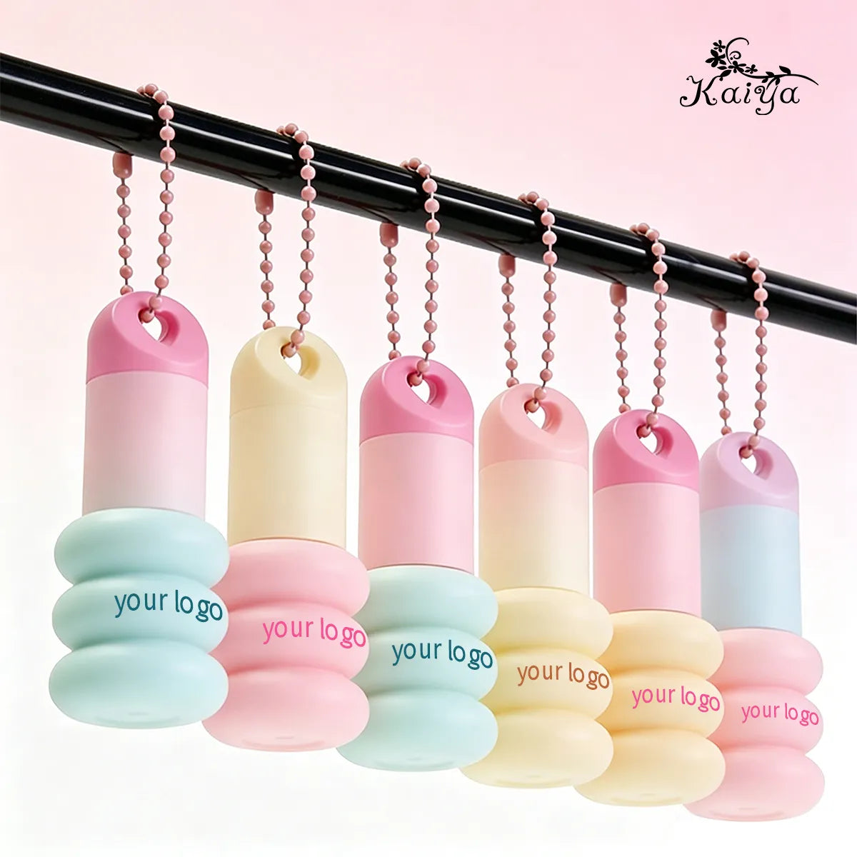 Custom keychain lip gloss tubes in pink, cream and blue with decorative bead chains for handbag attachment by KAIYA.