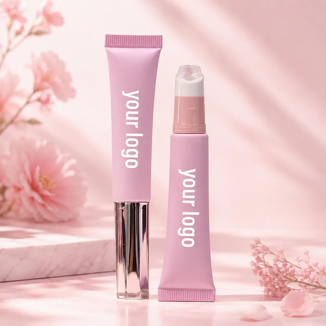 Kaiya lip oil squeeze tube packaging in soft pink with empty squeeze tube and applicator-style lip oil container design.