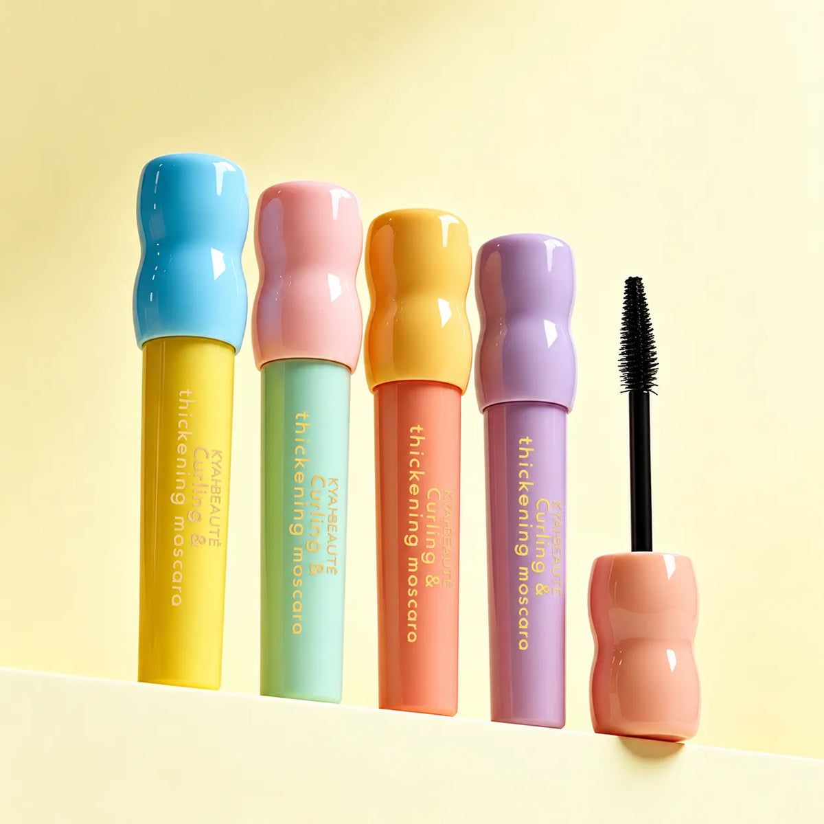 KAIYA colorful curling mascara collection with pastel-colored tubes and a mascara brush, showcasing private label eye makeup manufacturing.