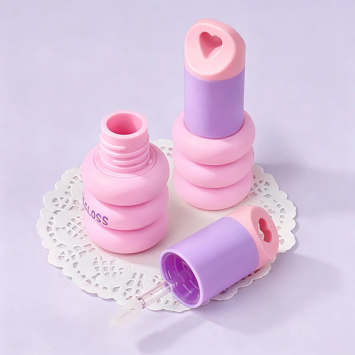 Kaiya pink lip gloss tubes with heart-shaped applicator design for custom lip gloss packaging projects