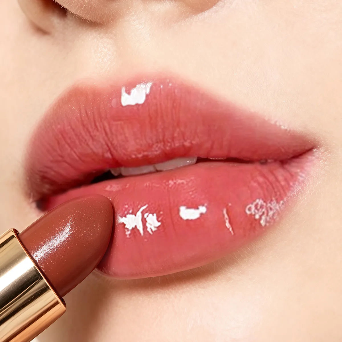 Close-up of glossy lips wearing plumping lip balm with a smooth, fuller-looking finish.