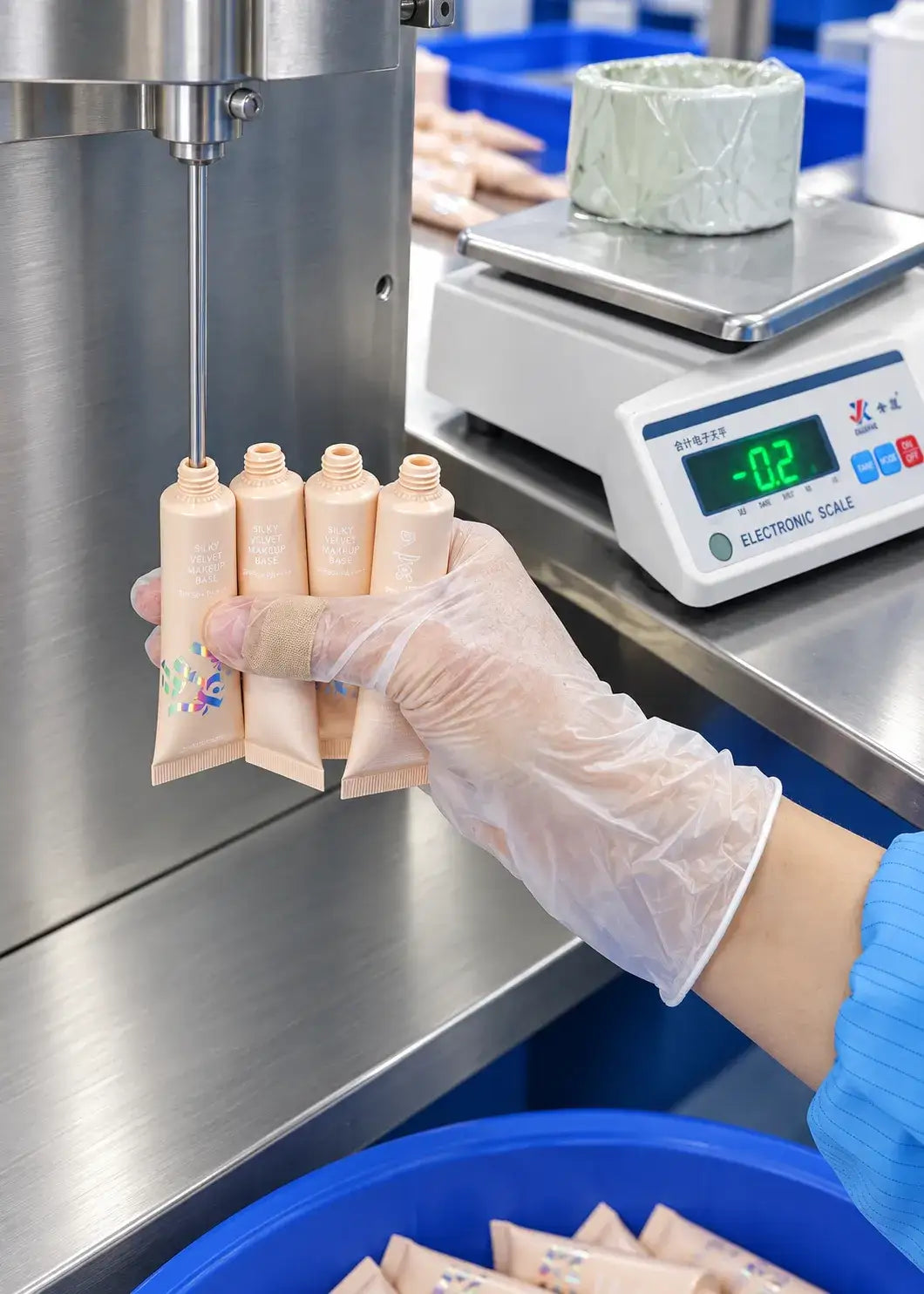 Workers filling and assembling private label lip oil tubes at KAIYA, a lip oil manufacturer.