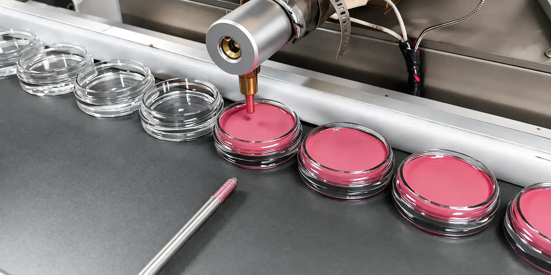 KAIYA turnkey cosmetics manufacturing showing automated filling of pink cosmetic formula into jars on the production line