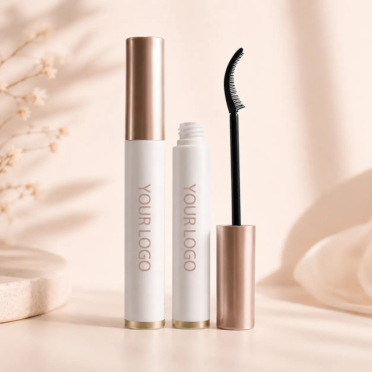 Kaiya empty mascara tube and wand with white mascara tube, rose gold cap, and curved brush applicator packaging.