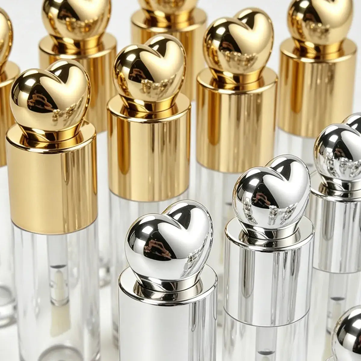 Custom lip gloss bottles with gold and silver metallic surface finishing and decorative caps