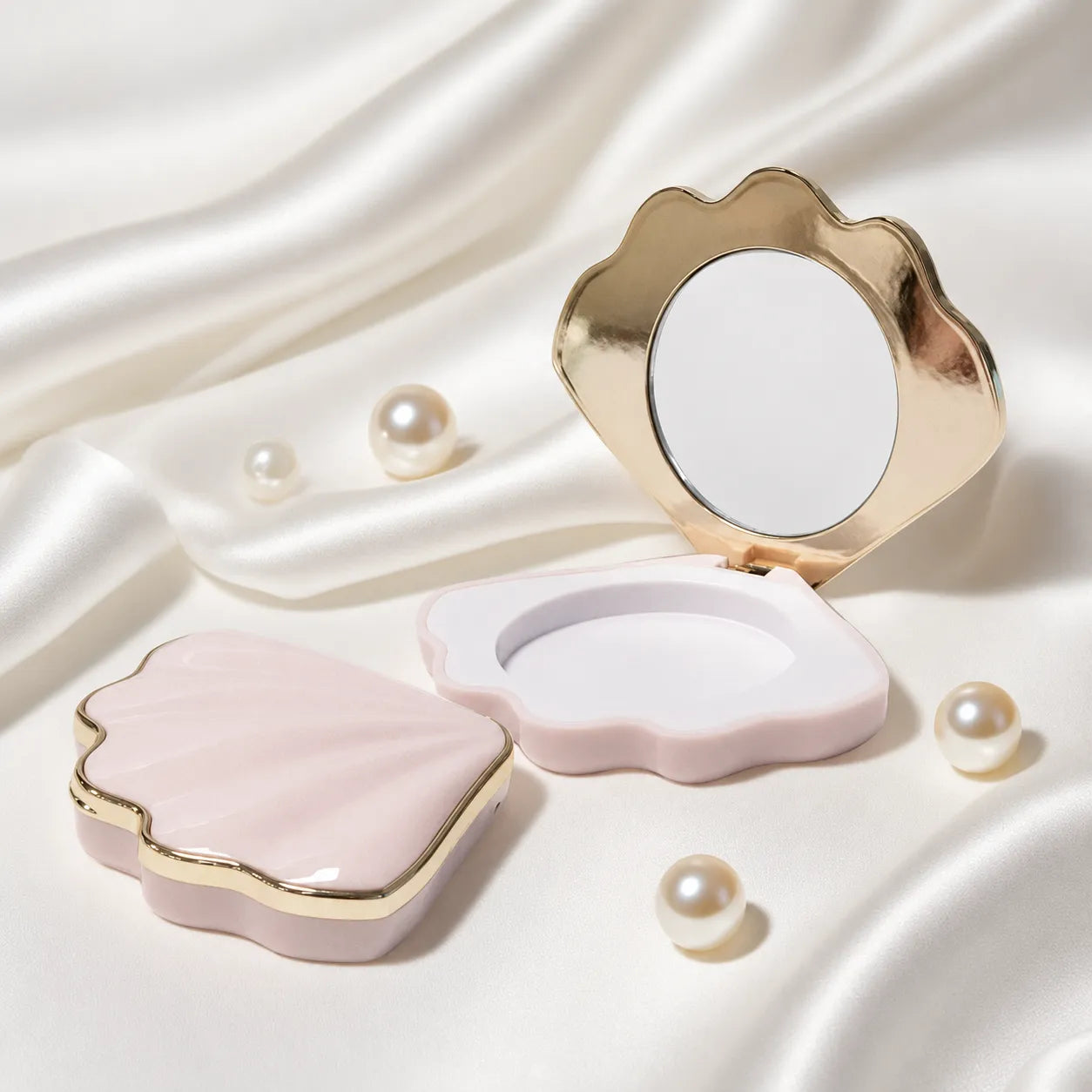 Empty pressed powder compact in a shell-shaped pink case with mirror and gold trim for Kaiya cosmetic packaging.