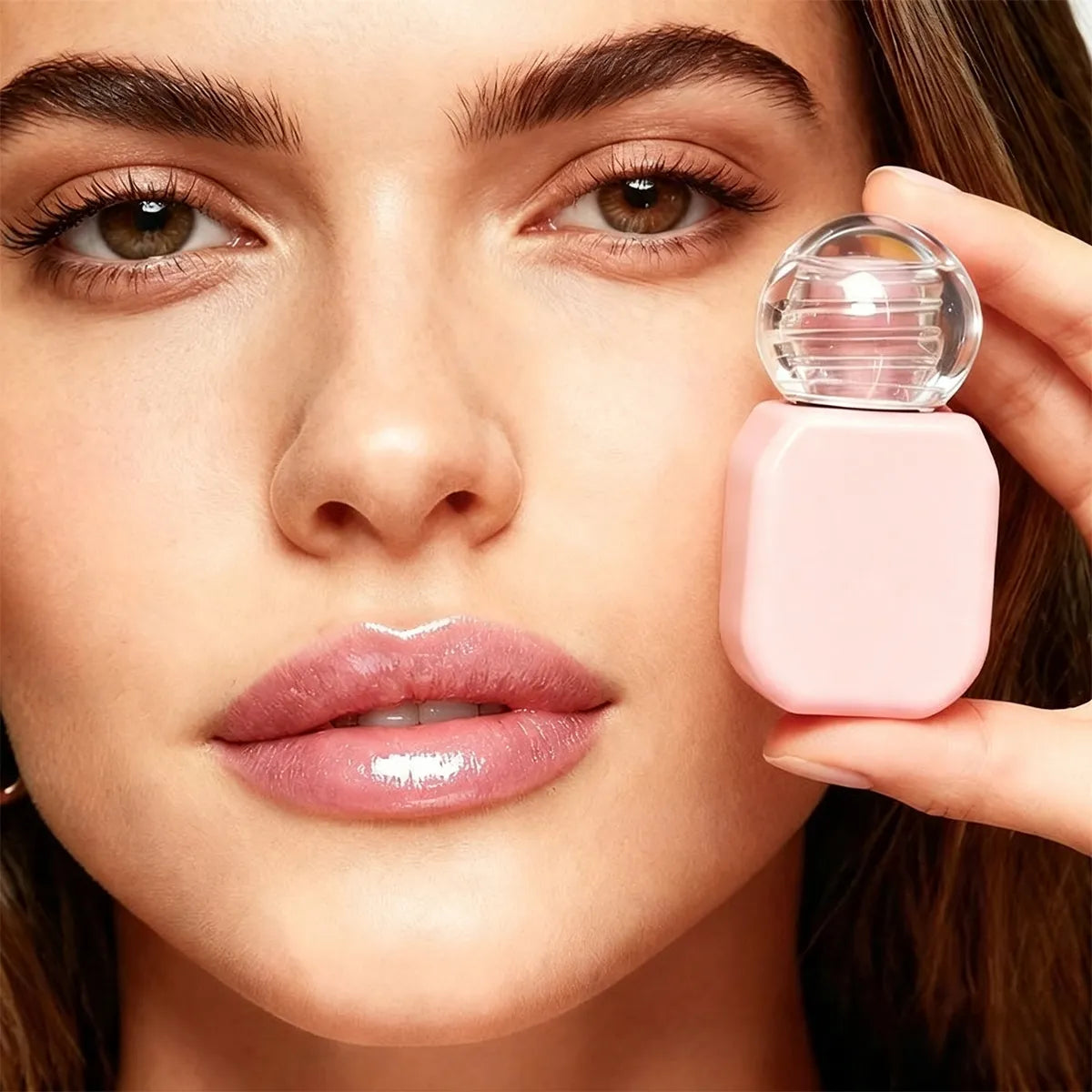 Clear lip gloss top coat layered over pink lip color to add transparent shine