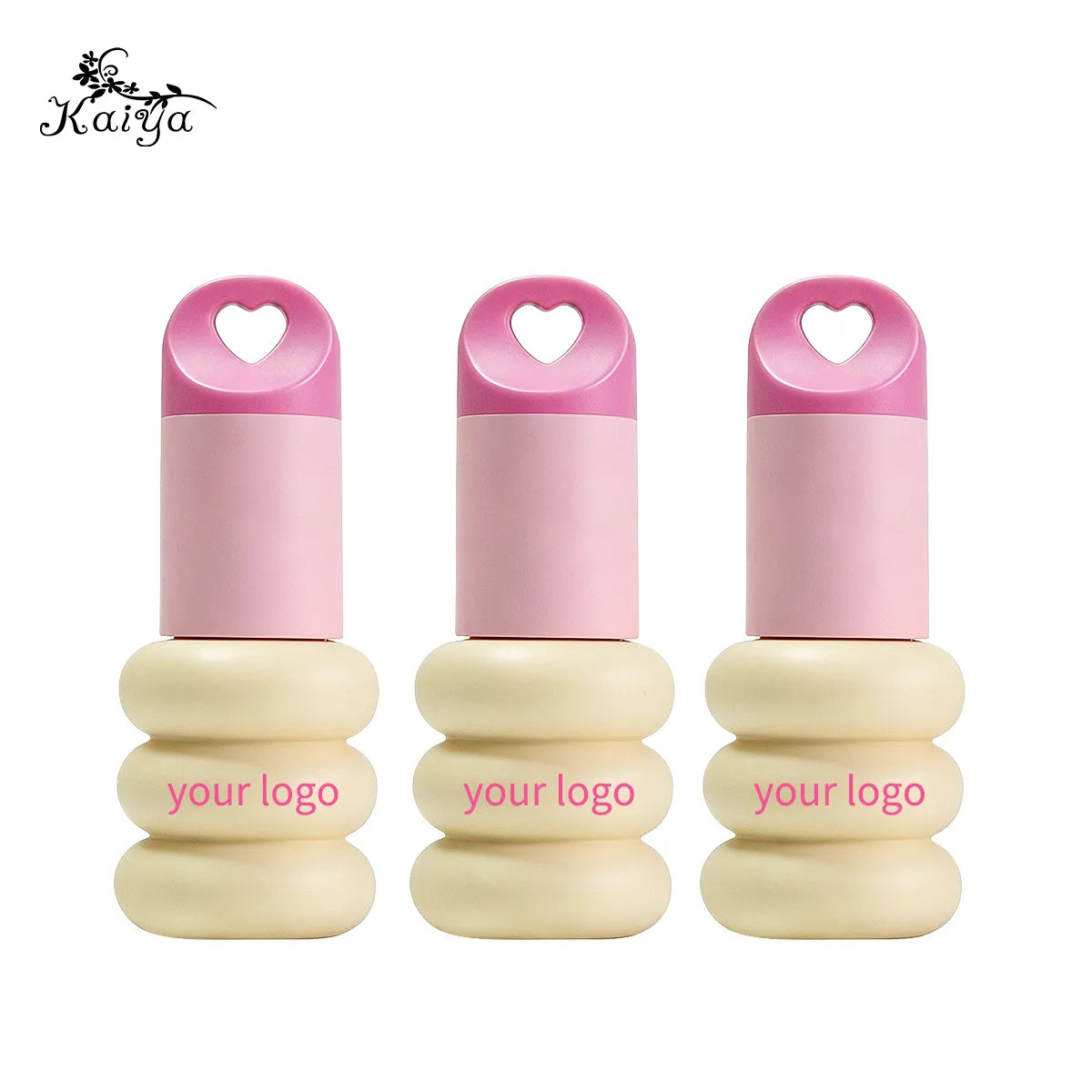 Three keychain lip gloss tubes featuring heart-shaped hanging holes, rounded cream-colored bodies and pink caps by KAIYA.