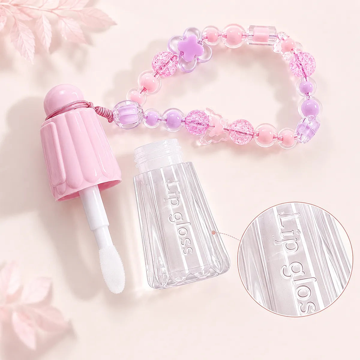 Keychain lip gloss tubes with laser engraving detail and empty applicator packaging