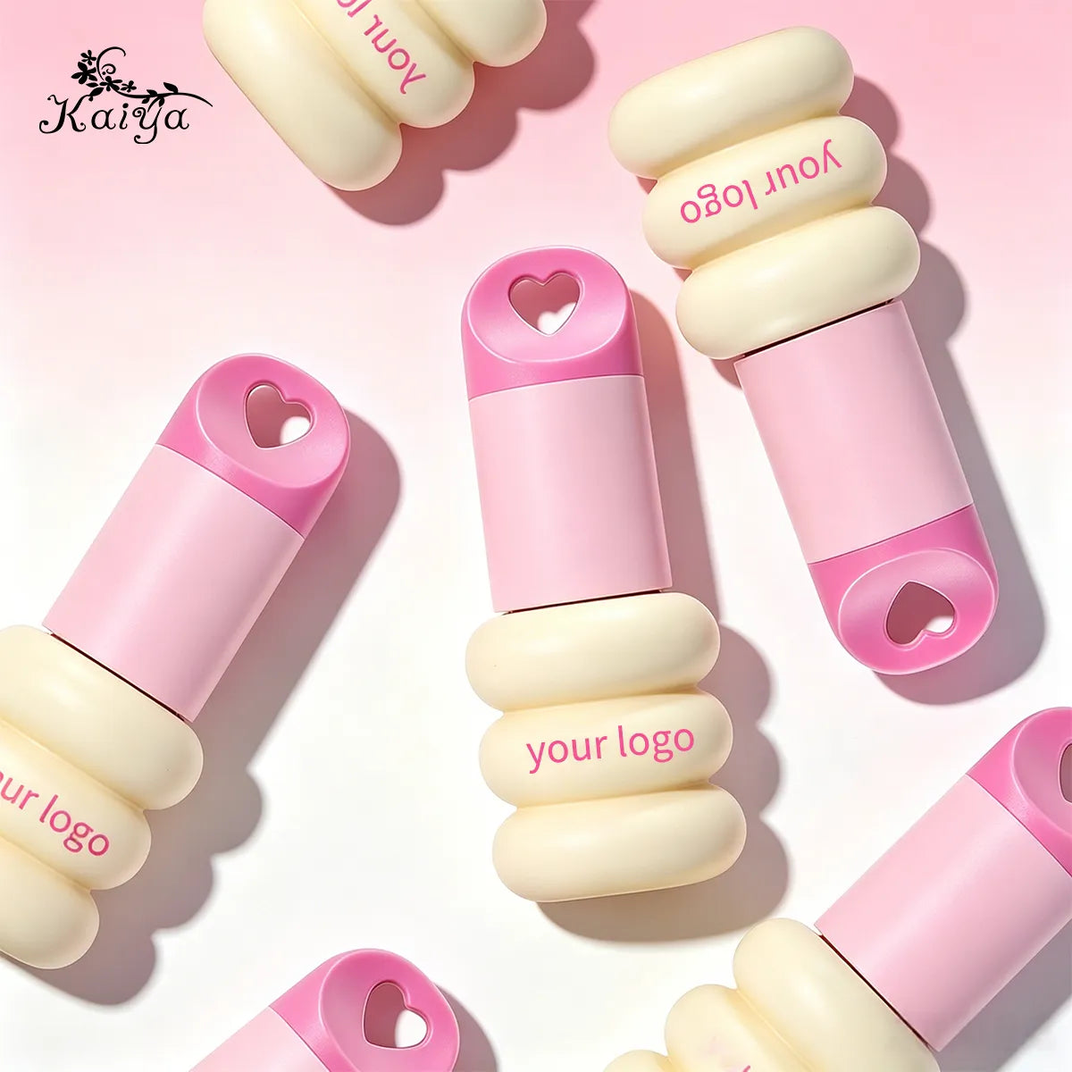 Keychain lip gloss tubes featuring playful stacked shapes, heart-shaped caps and coordinated pink and cream color combinations.