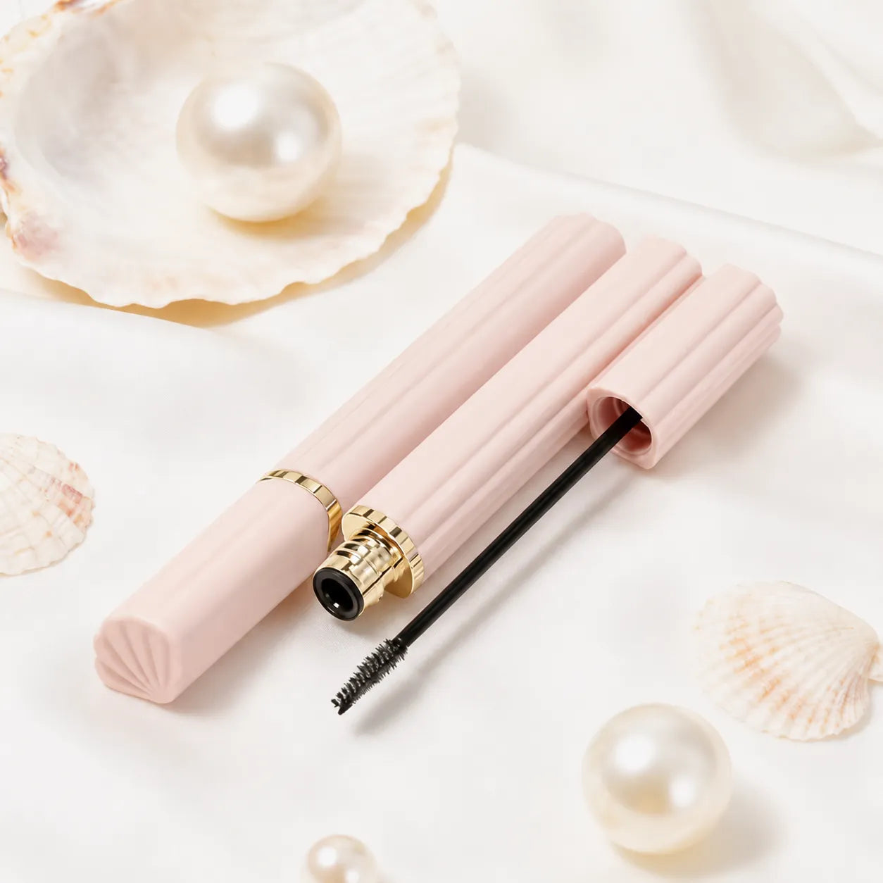 Kaiya light pink mascara bottle with ribbed tube design and gold accent.
