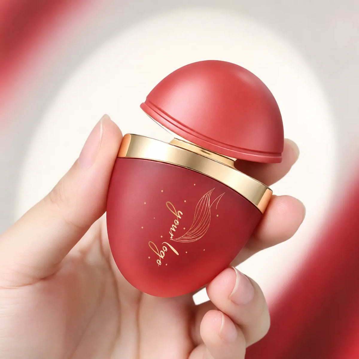 Custom lip gloss containers featuring a unique round dome shape, red matte finish, and gold decorative ring for cosmetic brands