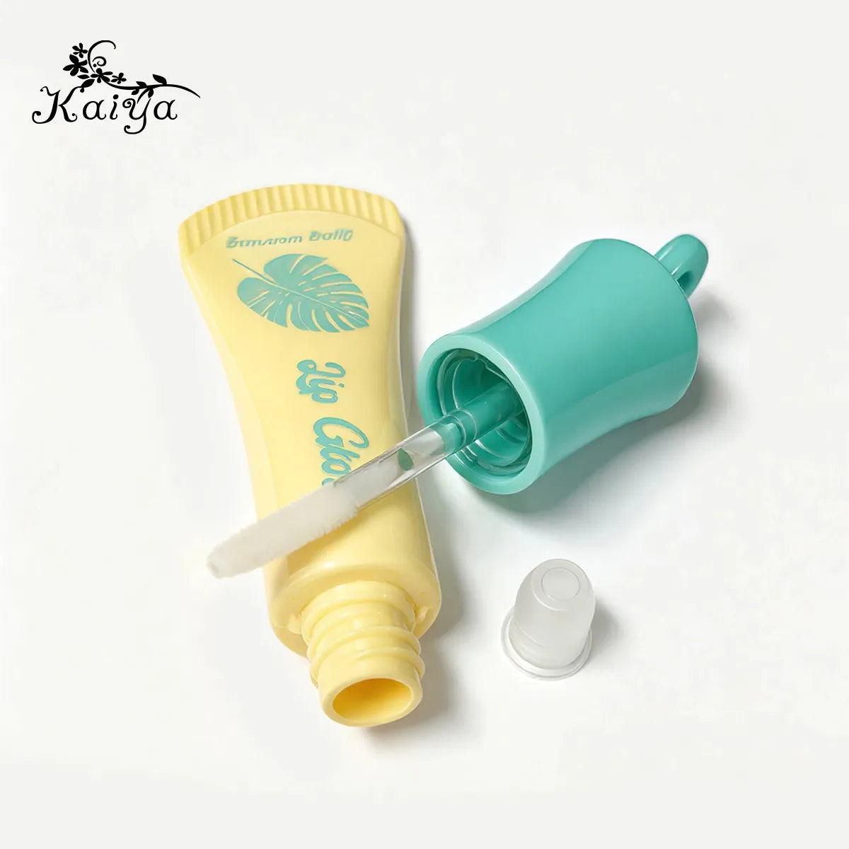 Lip gloss tube with applicator showing wand, wiper and packaging components
