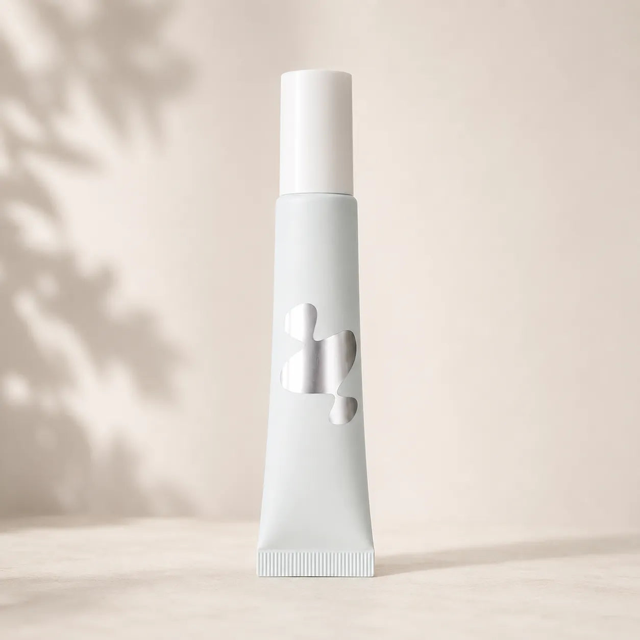 Kaiya liquid foundation bottles with silver hot stamping detail on a white squeeze tube, showing custom cosmetic packaging decoration.
