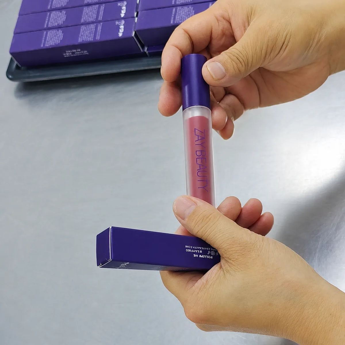 Finished liquid lipstick tube and carton checked for assembly and packaging appearance