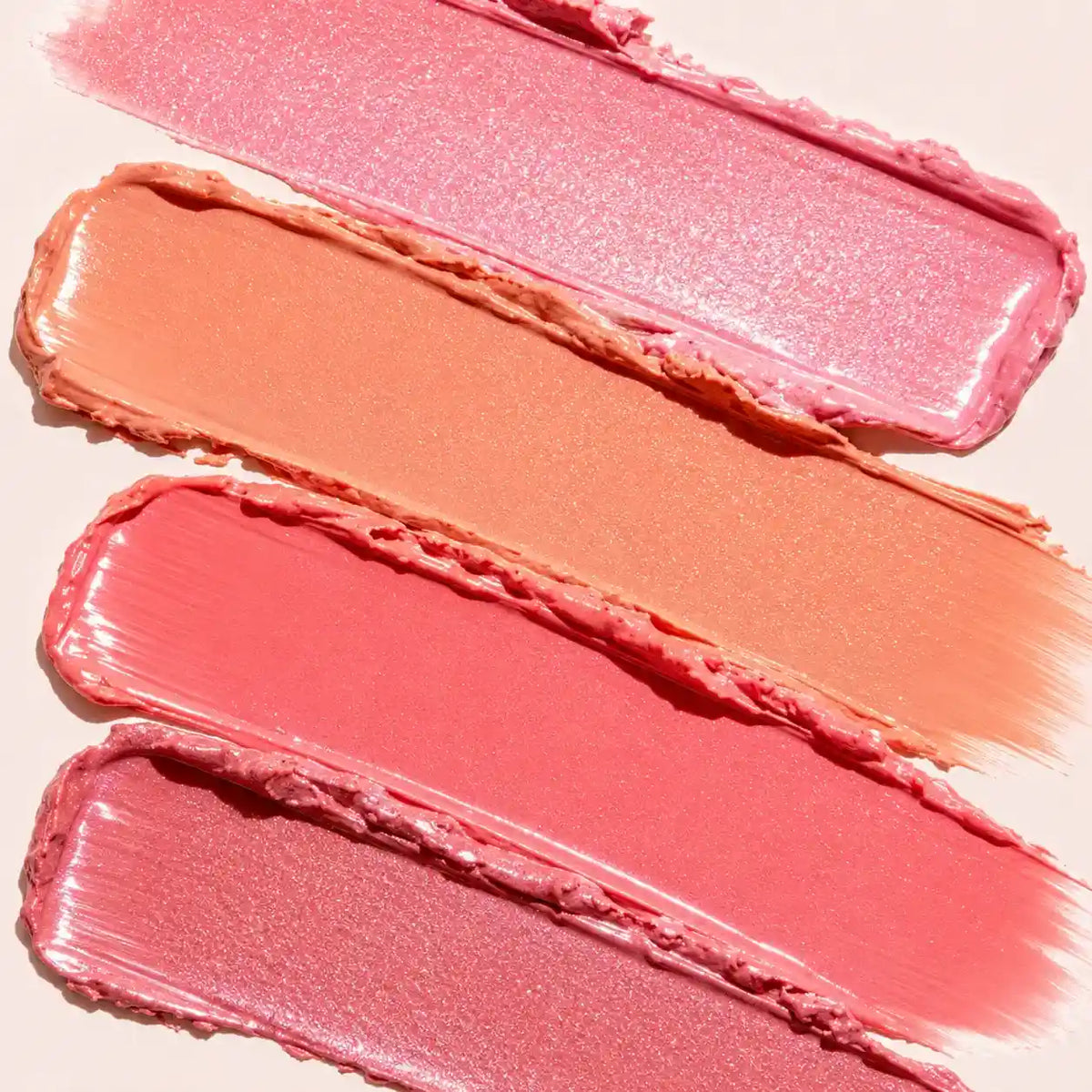 Liquid lipstick formula swatches showing pink, peach, coral and rose color payoff