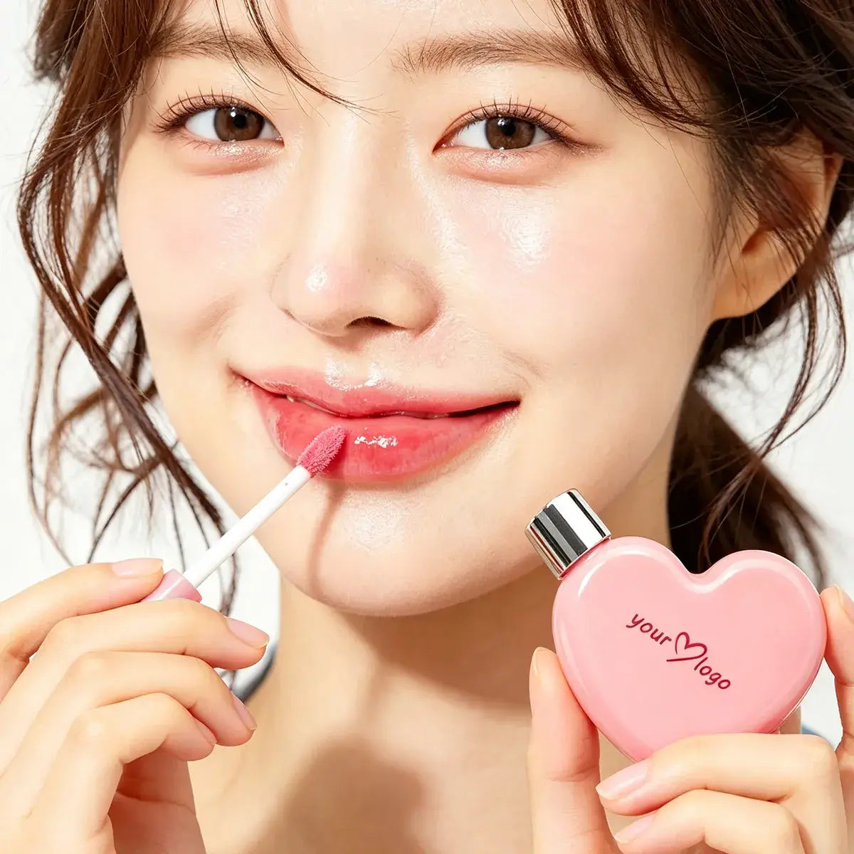 Model wearing sheer pink mirror lip gloss with a translucent, glass-like finish.