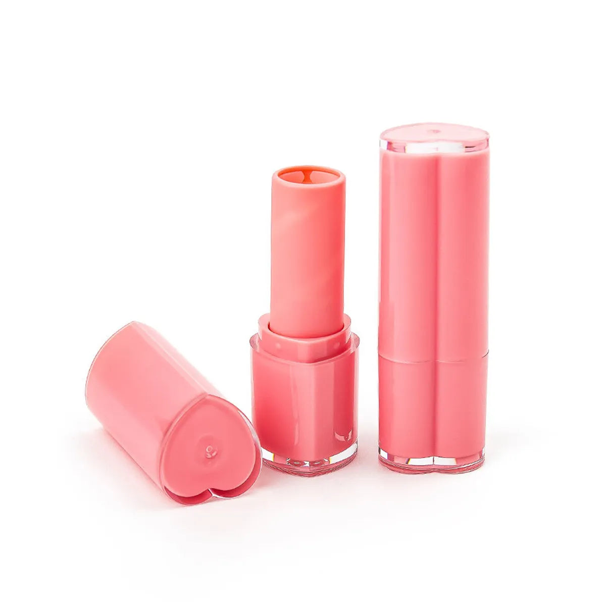 Plastic lip balm tubes in pink packaging design by Kaiya