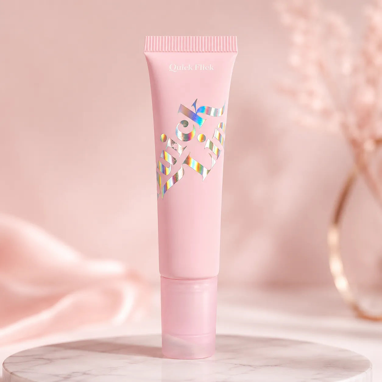 Kaiya pretty lip gloss containers with holographic hot stamping cosmetic packaging details on a pink squeeze tube.