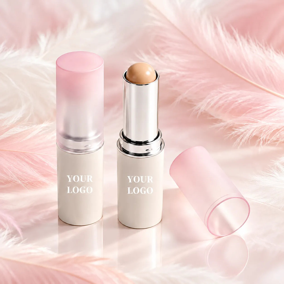 Private label concealer stick with a rounded cream tip, silver applicator holder and frosted pink cap by KAIYA.