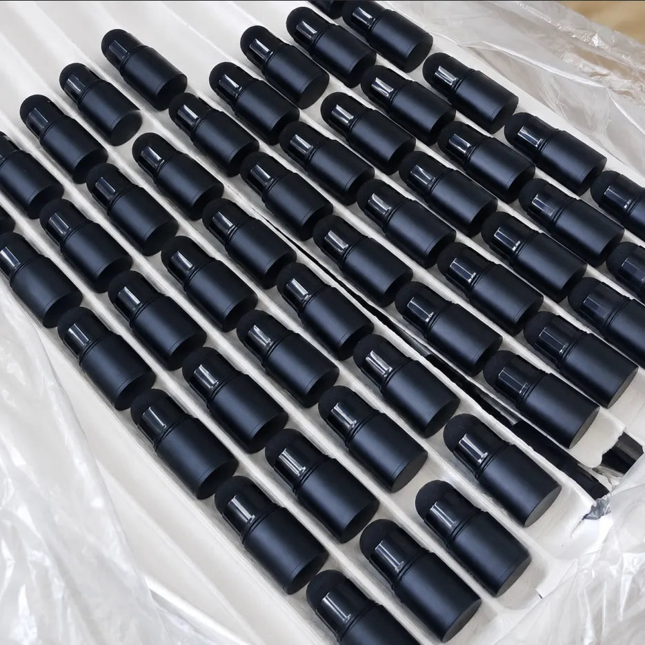 Private label cosmetic containers by KAIYA, featuring black empty stick packaging in tray inspection for makeup packaging manufacturers.