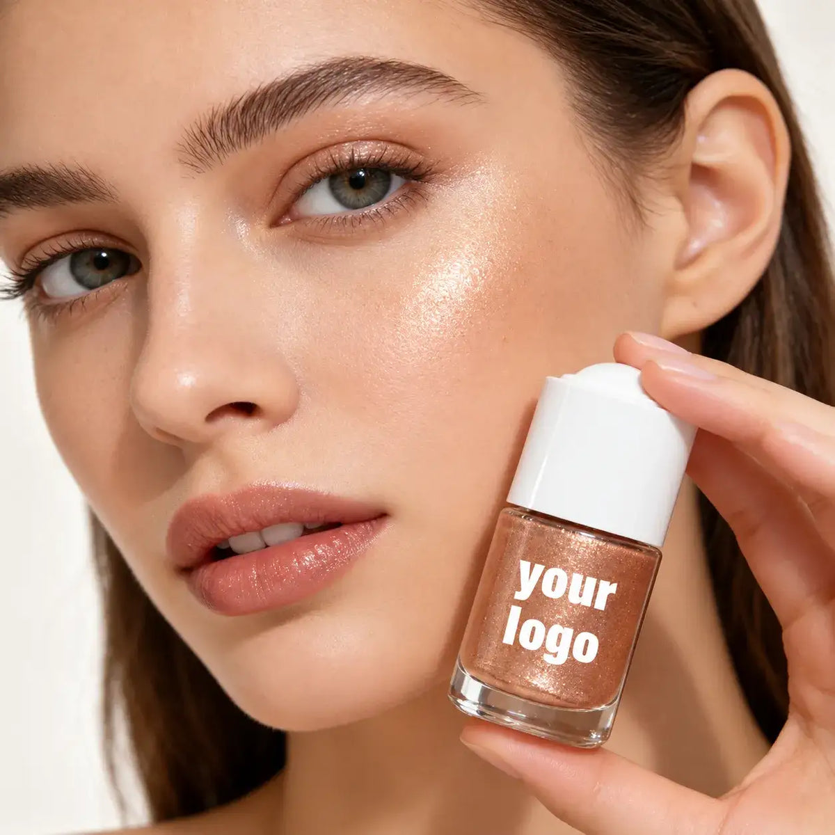 Private label highlighter makeup shown with a model wearing a luminous cheek highlight and holding a YOUR LOGO bottle.