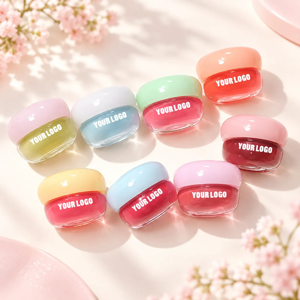 Colorful private label lip mask jars with custom-logo labels arranged on a pink background