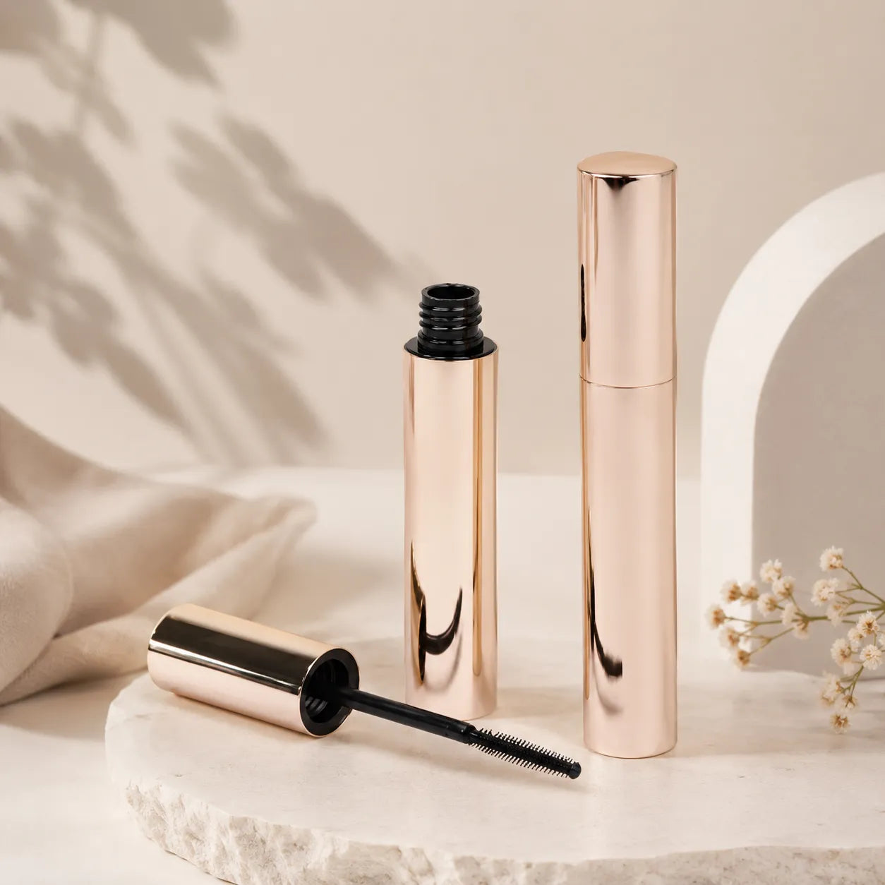 Kaiya rose gold mascara bottle with matching brush applicator packaging.
