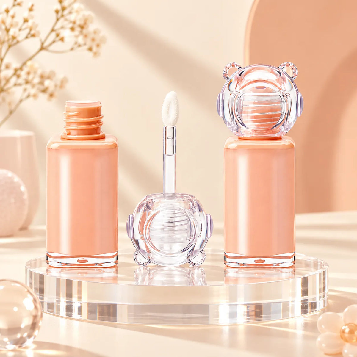 Kaiya small lip gloss containers with empty mini lip gloss tubes, decorative clear caps and doe-foot applicators for custom cosmetic projects.