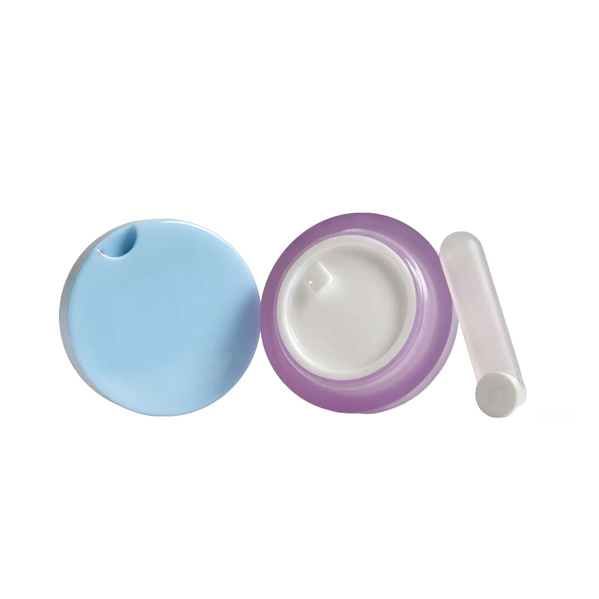 Small lip scrub containers in blue and purple designs by Kaiya
