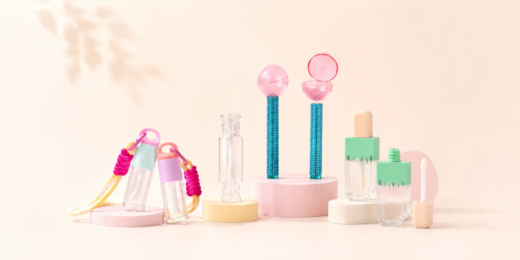 Kaiya kids makeup packaging with cute lip gloss packaging, including lanyard tubes, lollipop-shaped lip gloss tubes, a clear candy bottle, and popsicle-style containers.