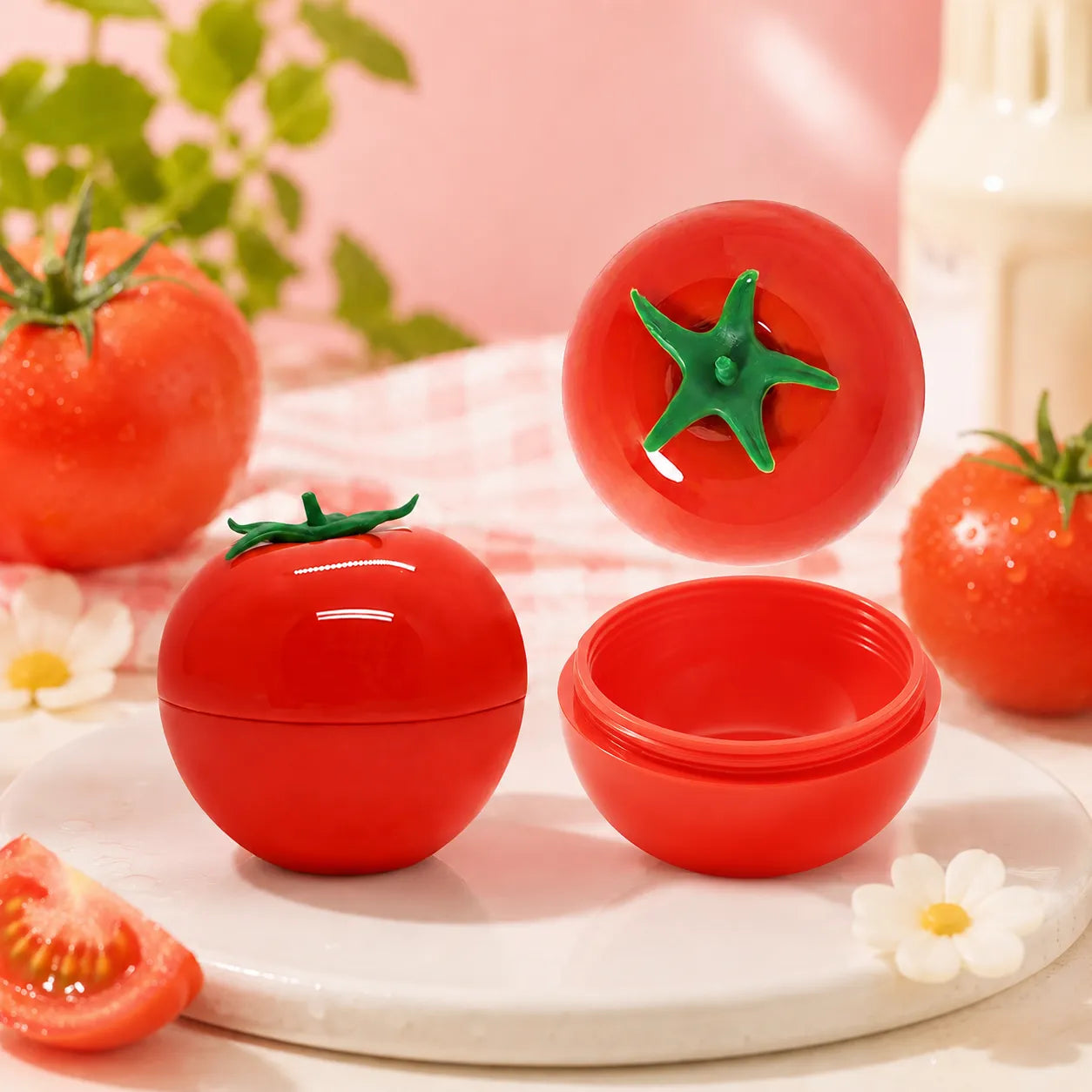 Lip balm jars with fun lip balm containers in tomato-shaped empty packaging, showing closed and open jar styles with a playful fruit-inspired design.
