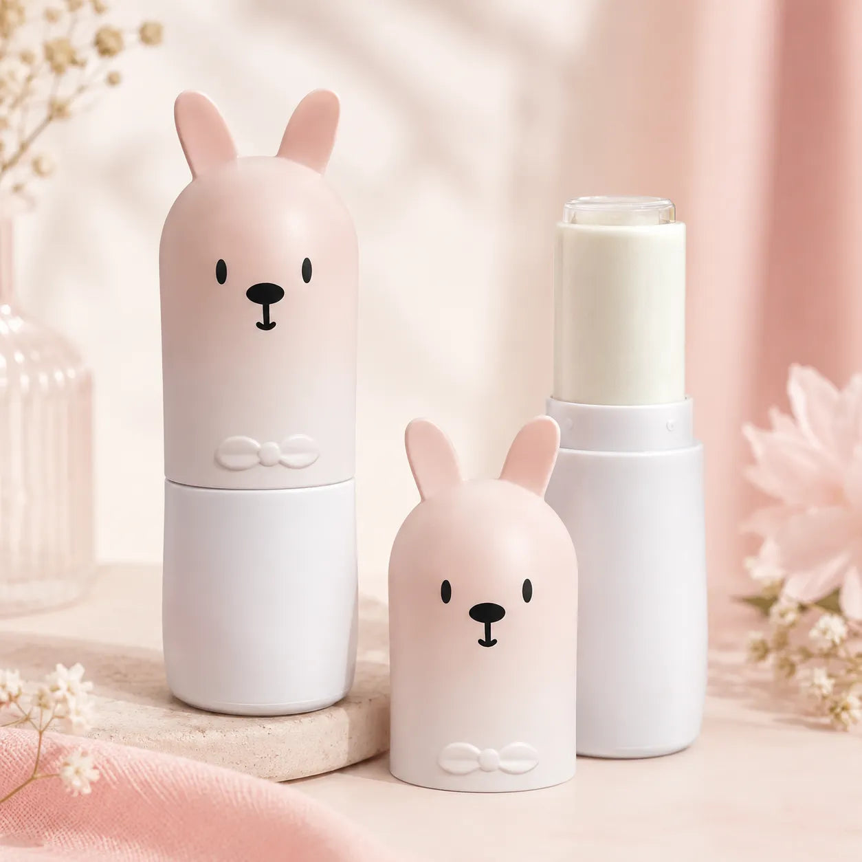 Lip balm packaging with bunny-shaped cap, bow detail, and pad printing face design for cute makeup packaging