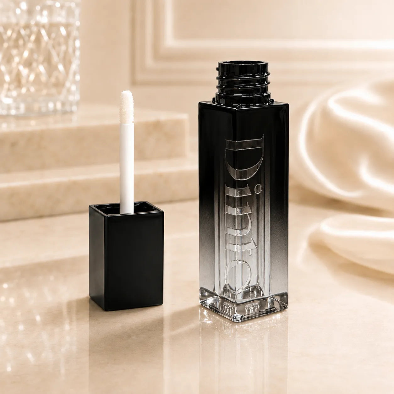 Lip gloss containers with laser engraving detail, black gradient clear bottle body, and premium cosmetic packaging design.