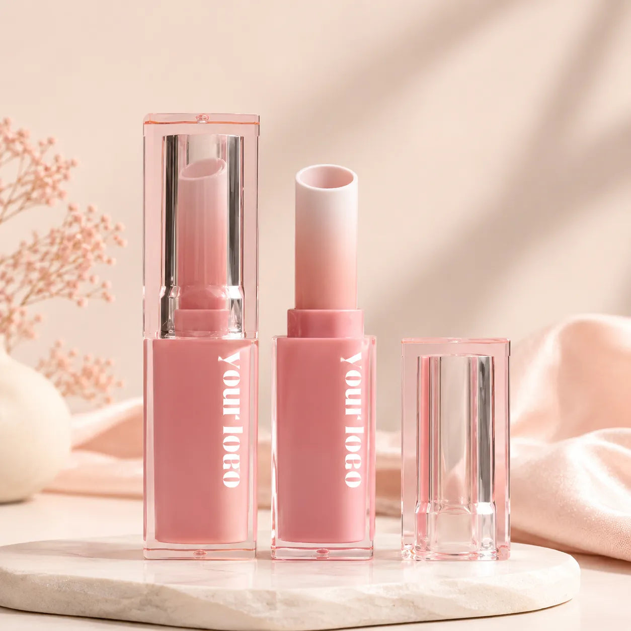 Pink lipstick tube with clear cap and matching base for custom empty lipstick packaging.