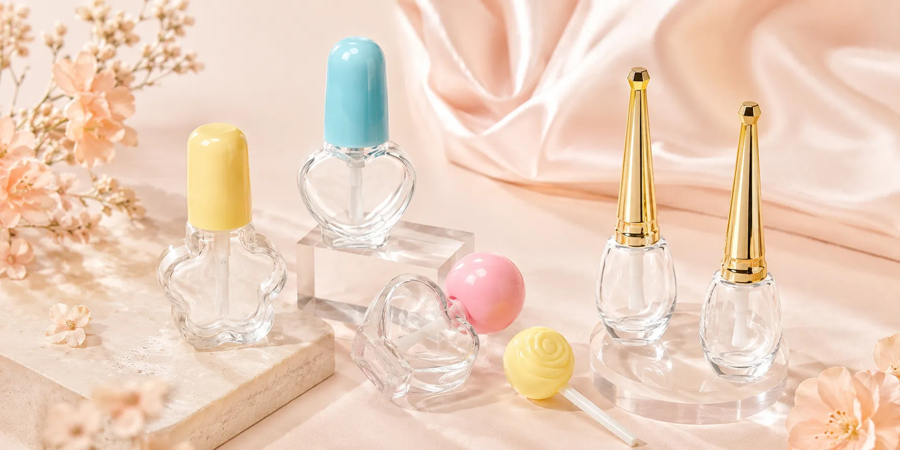 Wholesale nail polish bottles with clear glass bodies and gold caps displayed in a soft pastel cosmetic packaging scene.